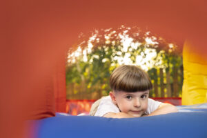 front-view-kid-laying-bounce-house