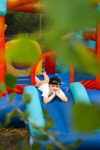 full-shot-smiley-boy-bounce-house_23-2149551613